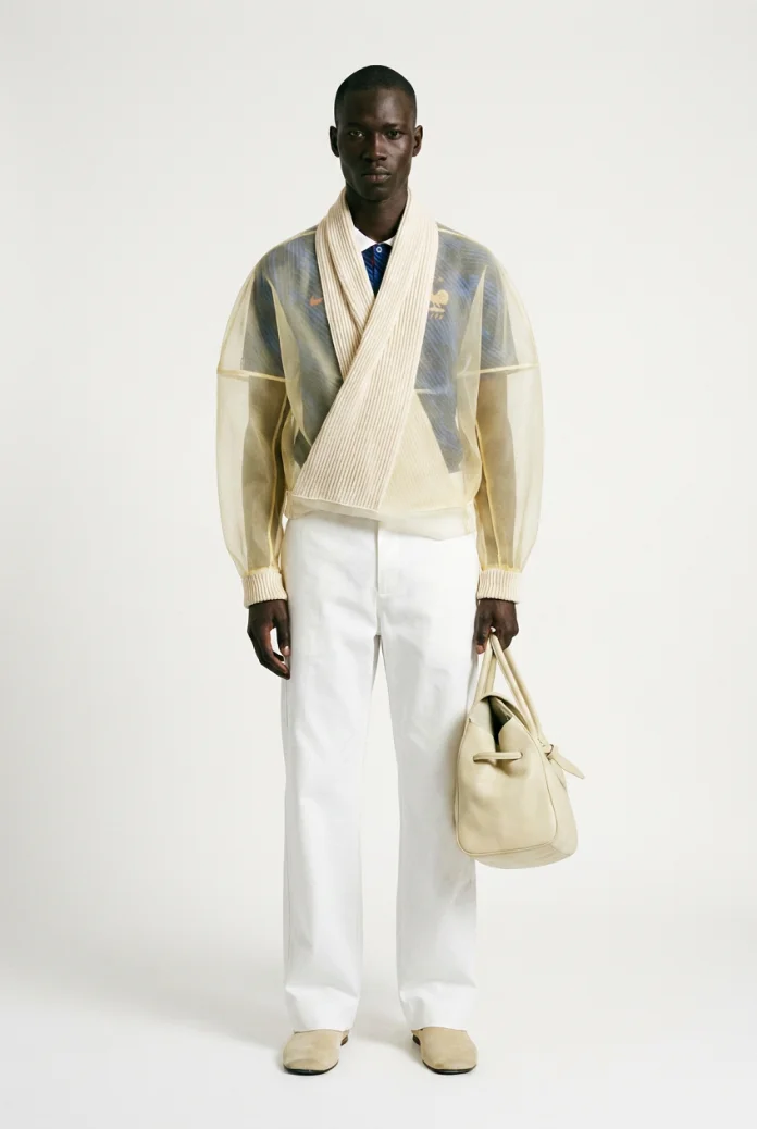 Model in sheer jacket and white trousers
