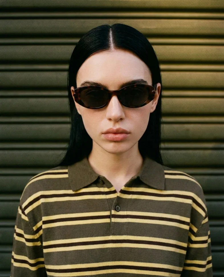 Model in striped polo and sunglasses